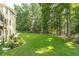 Spacious backyard with a lush lawn, mature trees, and well-manicured landscaping offers serene outdoor living at 1432 Arbor Bluff Ct, Lawrenceville, GA 30045