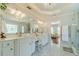 A bright bathroom featuring marble floors, white cabinetry, and a glass shower at 1432 Arbor Bluff Ct, Lawrenceville, GA 30045