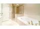 Bathroom featuring a soaking tub, glass shower, and tile flooring at 1432 Arbor Bluff Ct, Lawrenceville, GA 30045