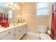 Cozy bathroom with a white vanity, neutral walls, and a window for natural light at 1432 Arbor Bluff Ct, Lawrenceville, GA 30045