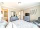 Bedroom featuring two dressers, a bed, a chair and access to the bathroom at 1432 Arbor Bluff Ct, Lawrenceville, GA 30045