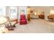 Primary bedroom suite with sitting area, carpeted floors, and natural light at 1432 Arbor Bluff Ct, Lawrenceville, GA 30045