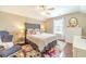 Well-lit bedroom with a large bed, decorative rug, furniture, and natural light at 1432 Arbor Bluff Ct, Lawrenceville, GA 30045