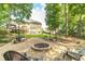 Backyard fire pit area offers additional seating, beautiful landscaping, and an inviting atmosphere at 1432 Arbor Bluff Ct, Lawrenceville, GA 30045
