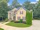 Lovely two-story home with manicured lawn, colorful landscaping, and inviting covered porch at 1432 Arbor Bluff Ct, Lawrenceville, GA 30045