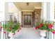 Inviting front porch with stone accents, double doors, and colorful potted plants at 1432 Arbor Bluff Ct, Lawrenceville, GA 30045