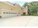 Three-car garage with ample parking space and a well-maintained driveway at 1432 Arbor Bluff Ct, Lawrenceville, GA 30045