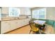 Eat-in kitchen with a window view, white cabinets, and a built-in booth seating area at 1432 Arbor Bluff Ct, Lawrenceville, GA 30045