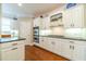 Modern kitchen featuring white cabinets, stainless steel appliances, granite countertops, and hardwood floors at 1432 Arbor Bluff Ct, Lawrenceville, GA 30045