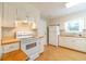Bright kitchen equipped with white appliances, ample cabinet space, and a wooden countertop at 1432 Arbor Bluff Ct, Lawrenceville, GA 30045