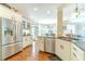 Bright, updated kitchen with stainless steel appliances, granite counters and hardwood floors adjacent to breakfast nook at 1432 Arbor Bluff Ct, Lawrenceville, GA 30045