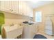 Laundry room with ample storage, utility sink, washer, and dryer at 1432 Arbor Bluff Ct, Lawrenceville, GA 30045