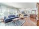 Open concept living room and bedroom featuring hardwood floors and many windows with natural light at 1432 Arbor Bluff Ct, Lawrenceville, GA 30045
