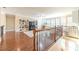 Upstairs loft area with hardwood floors, custom shelving, and ample natural light at 1432 Arbor Bluff Ct, Lawrenceville, GA 30045