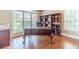 Home office featuring a large desk, hardwood floors, and built-in shelving for storage and organization at 1432 Arbor Bluff Ct, Lawrenceville, GA 30045