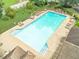 Inviting community swimming pool with lounge chairs and tables for relaxation on a sunny day at 1432 Arbor Bluff Ct, Lawrenceville, GA 30045