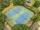 Aerial view of well-maintained community tennis courts surrounded by lush trees at 1432 Arbor Bluff Ct, Lawrenceville, GA 30045