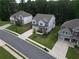 Aerial view of three homes on a street in a community lined with mature trees at 5394 Pebblebrook Se Ln, Mableton, GA 30126
