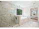 Main bathroom featuring walk in shower and tub with marble tile throughout at 5394 Pebblebrook Se Ln, Mableton, GA 30126