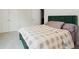 Bedroom boasts neutral colored walls, a modern green bedframe and plush bedding at 5394 Pebblebrook Se Ln, Mableton, GA 30126