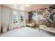 Lovely bedroom showcasing a picturesque tree mural and two cozy cribs at 5394 Pebblebrook Se Ln, Mableton, GA 30126