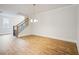 Dining room area with hardwood floors, staircase and modern light fixture at 5394 Pebblebrook Se Ln, Mableton, GA 30126