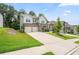 Attractive two-story home with stone accents, gray siding, well-kept lawn, and a spacious driveway at 5394 Pebblebrook Se Ln, Mableton, GA 30126