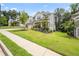Beautiful home with lush green lawn, stone accents, gray siding, and well-maintained landscaping at 5394 Pebblebrook Se Ln, Mableton, GA 30126