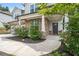 Inviting front entrance with stone pillars, a gray front door, and manicured landscaping at 5394 Pebblebrook Se Ln, Mableton, GA 30126