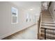 Bright hallway featuring hardwood floors, natural light, and an adjacent staircase at 5394 Pebblebrook Se Ln, Mableton, GA 30126