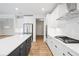Spacious kitchen with white cabinets, large island with dark cabinets, and stainless steel appliances at 5394 Pebblebrook Se Ln, Mableton, GA 30126