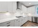 Modern kitchen featuring white cabinetry, subway tile backsplash, and stainless steel appliances at 5394 Pebblebrook Se Ln, Mableton, GA 30126