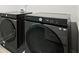 Modern laundry room showcasing front-load washer and dryer units, maximizing space and efficiency at 5394 Pebblebrook Se Ln, Mableton, GA 30126