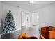 Spacious living room with hardwood floors, elegant trim, and a decorative Christmas tree at 5394 Pebblebrook Se Ln, Mableton, GA 30126