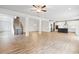 Open concept living space with hardwood floors, white columns, staircase, and modern kitchen at 5394 Pebblebrook Se Ln, Mableton, GA 30126