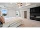 Spacious main bedroom featuring a tray ceiling, ceiling fan, and black modern fireplace at 5394 Pebblebrook Se Ln, Mableton, GA 30126