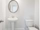 Clean powder room featuring a pedestal sink, neutral wall color, and modern fixtures at 5394 Pebblebrook Se Ln, Mableton, GA 30126