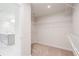 Large walk-in closet featuring neutral carpet and wire shelving located off a Primary bathroom with marble floors and a double vanity at 5394 Pebblebrook Se Ln, Mableton, GA 30126