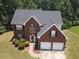 Charming two-story red brick home featuring a two-car garage and well-manicured lawn at 856 Haydens Rdg, Ellenwood, GA 30294