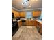 Well-lit kitchen featuring honey oak cabinets, stainless steel appliances, and gray tile flooring at 856 Haydens Rdg, Ellenwood, GA 30294
