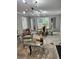 Open-concept living room with modern lighting, dining area, and comfortable seating at 856 Haydens Rdg, Ellenwood, GA 30294