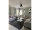Comfortable living room with neutral gray furniture, ceiling fan, and decorative mirror accents at 856 Haydens Rdg, Ellenwood, GA 30294
