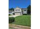 Charming two-story home features a manicured lawn, attached two-car garage and mature trees at 4209 Resheemah St, Atlanta, GA 30349