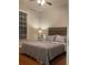 Bedroom with hardwood floors, a decorative wood headboard, and a large window at 727 Pear Grove Pl, Marietta, GA 30066