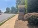 Hamilton Grove community entrance featuring brick signage, manicured landscaping, and a sidewalk at 727 Pear Grove Pl, Marietta, GA 30066