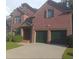 Beautiful two story brick home featuring a two-car garage, manicured landscaping, and classic architectural details at 727 Pear Grove Pl, Marietta, GA 30066