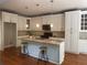 Bright open kitchen with a central island, custom cabinetry, granite countertops, and hardwood flooring at 727 Pear Grove Pl, Marietta, GA 30066