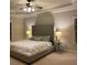 Comfortable main bedroom with a large upholstered headboard, ceiling fan, and neutral color palette at 727 Pear Grove Pl, Marietta, GA 30066