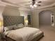 Serene main bedroom featuring a tufted headboard, tray ceilings, ceiling fan and a tranquil atmosphere at 727 Pear Grove Pl, Marietta, GA 30066