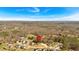 A sprawling landscape encompasses the property, nestled among trees and other homes, with a clear blue sky above at 81 Bridgemill Dr, Douglasville, GA 30134